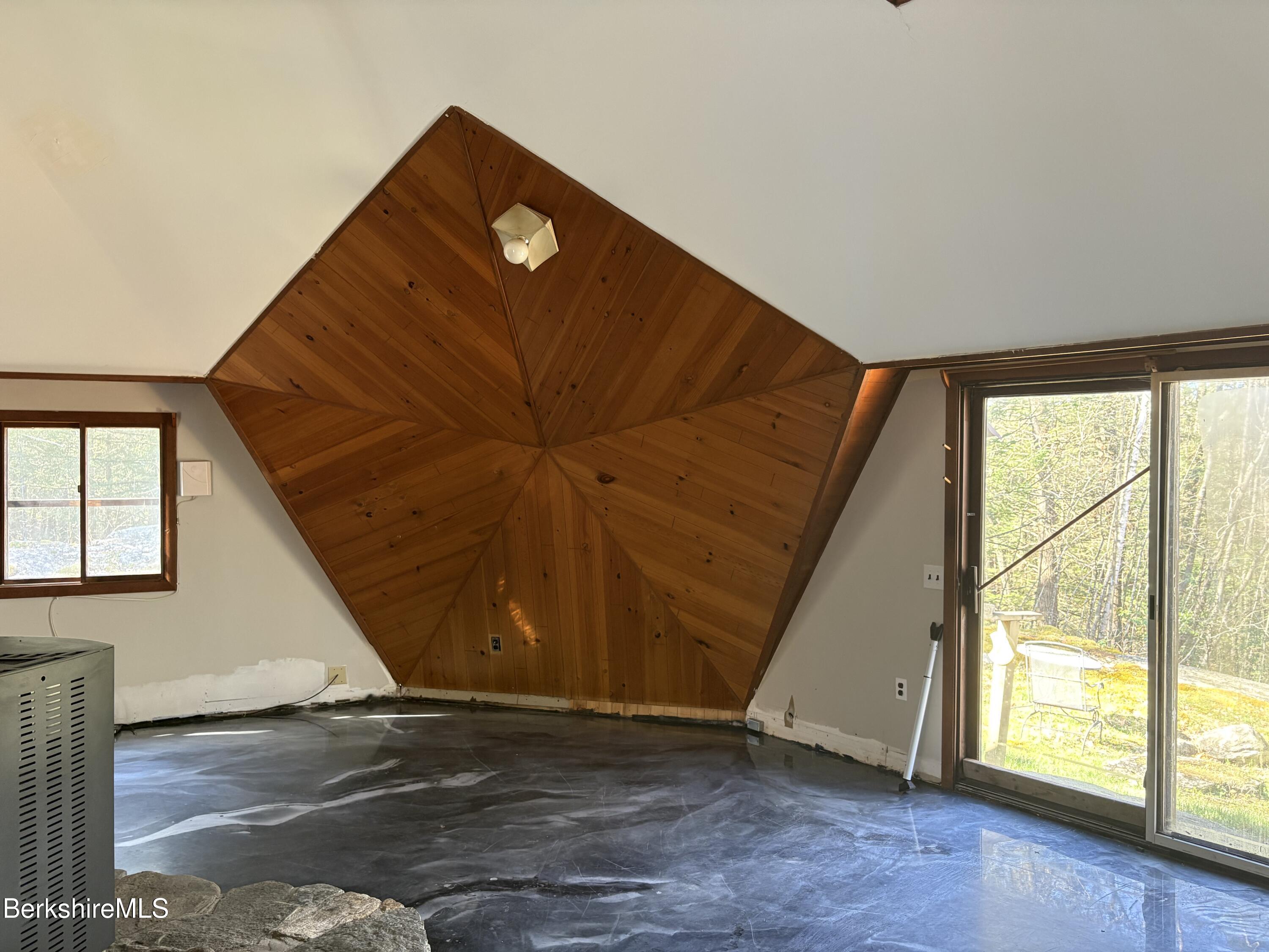 2110 West Center Road Otis, MA 01253 - Photo 9 of 24 an empty room with wooden floor and windows