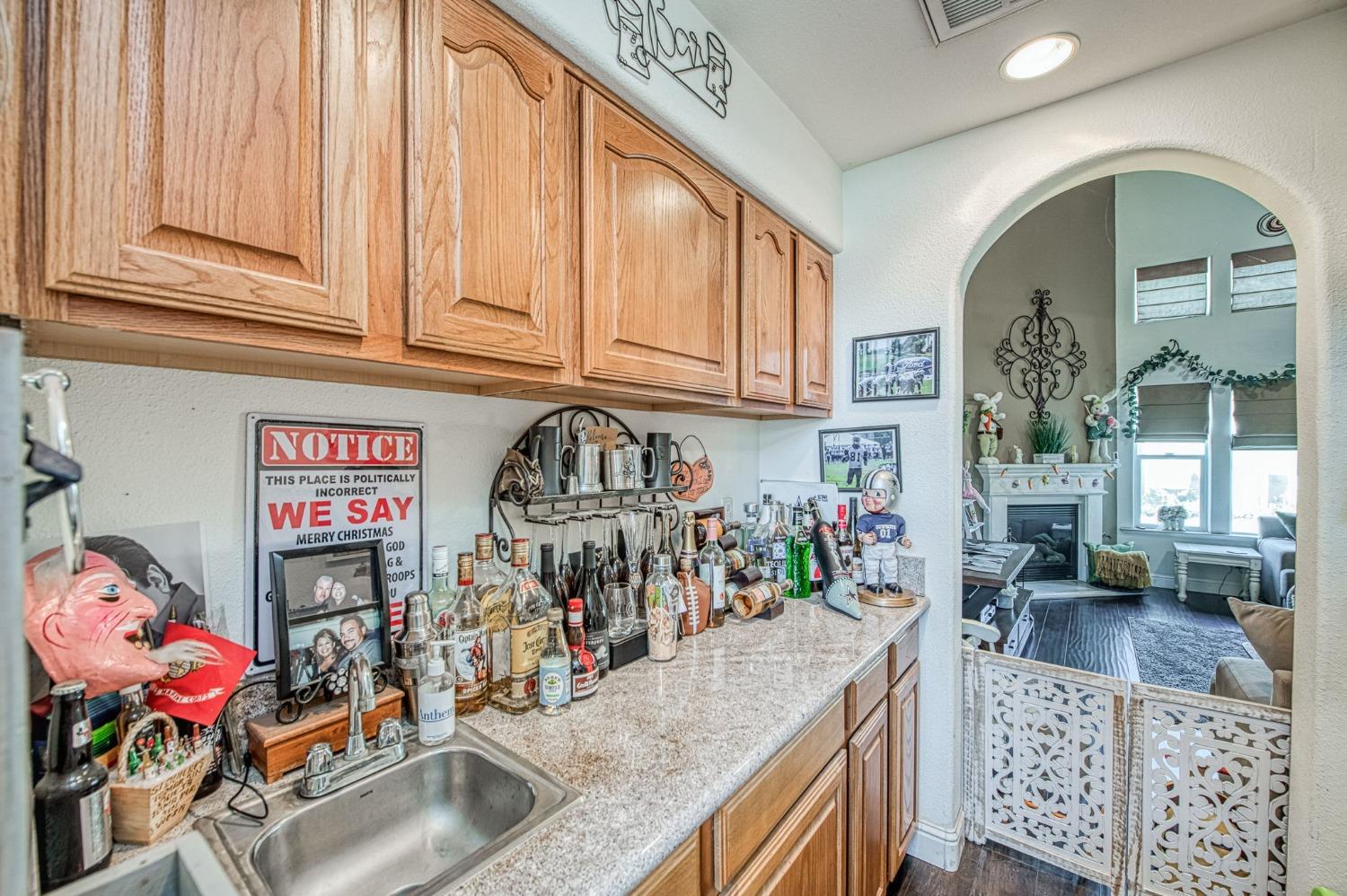 901 Maple Street Parlier, CA 93648 - Photo 22 of 67 a kitchen with lots of clutter and stainless steel appliances