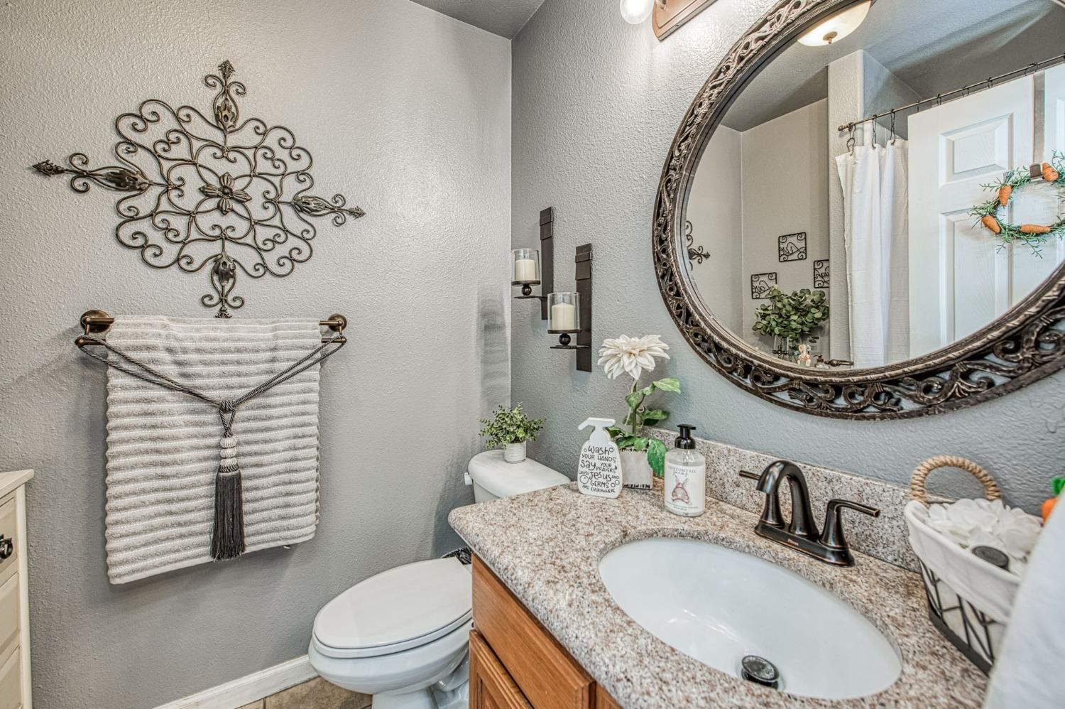 901 Maple Street Parlier, CA 93648 - Photo 3 of 67 a bathroom with a sink a toilet and a mirror