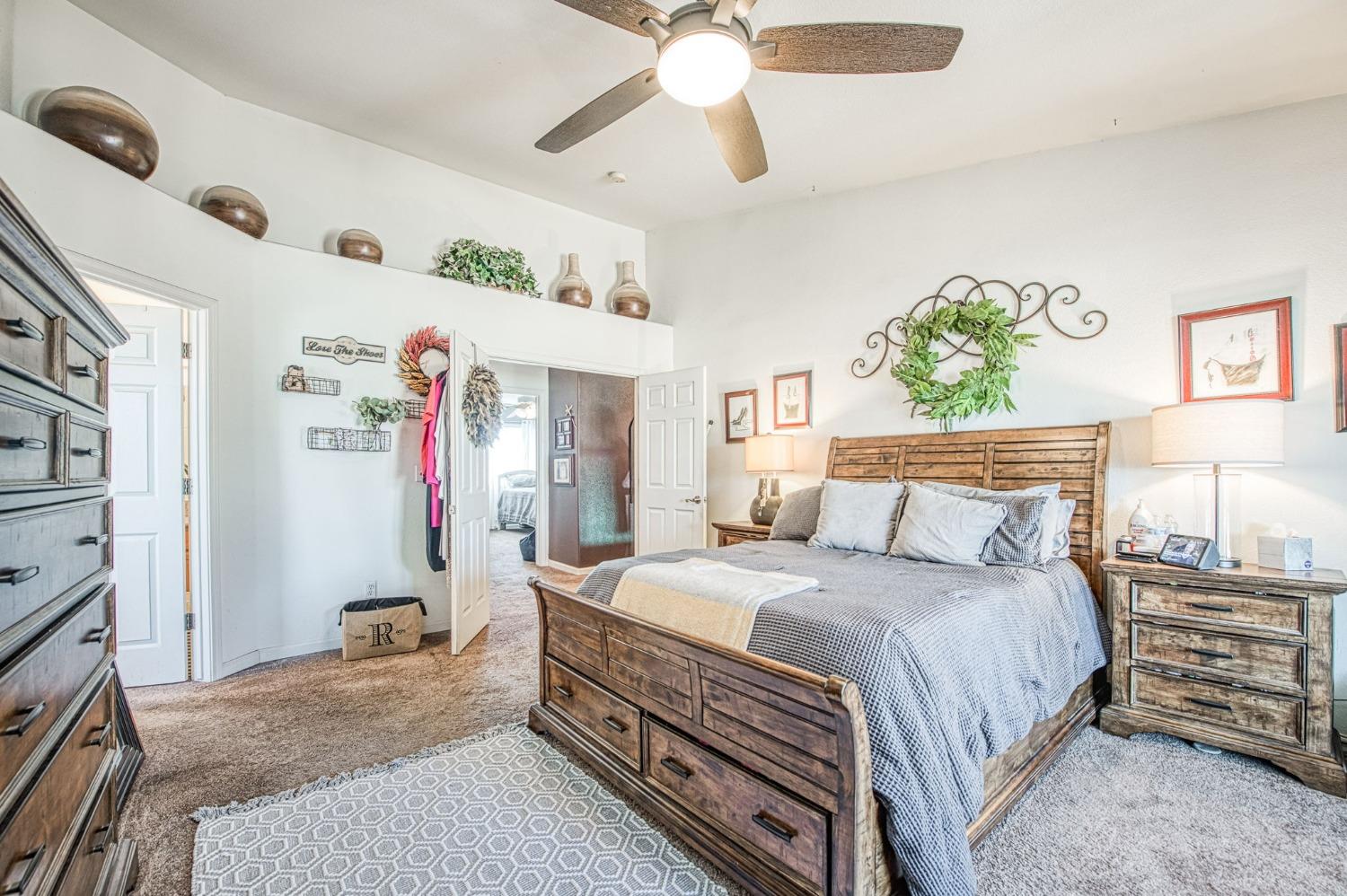 901 Maple Street Parlier, CA 93648 - Photo 35 of 67 a bedroom with a bed and a chandelier