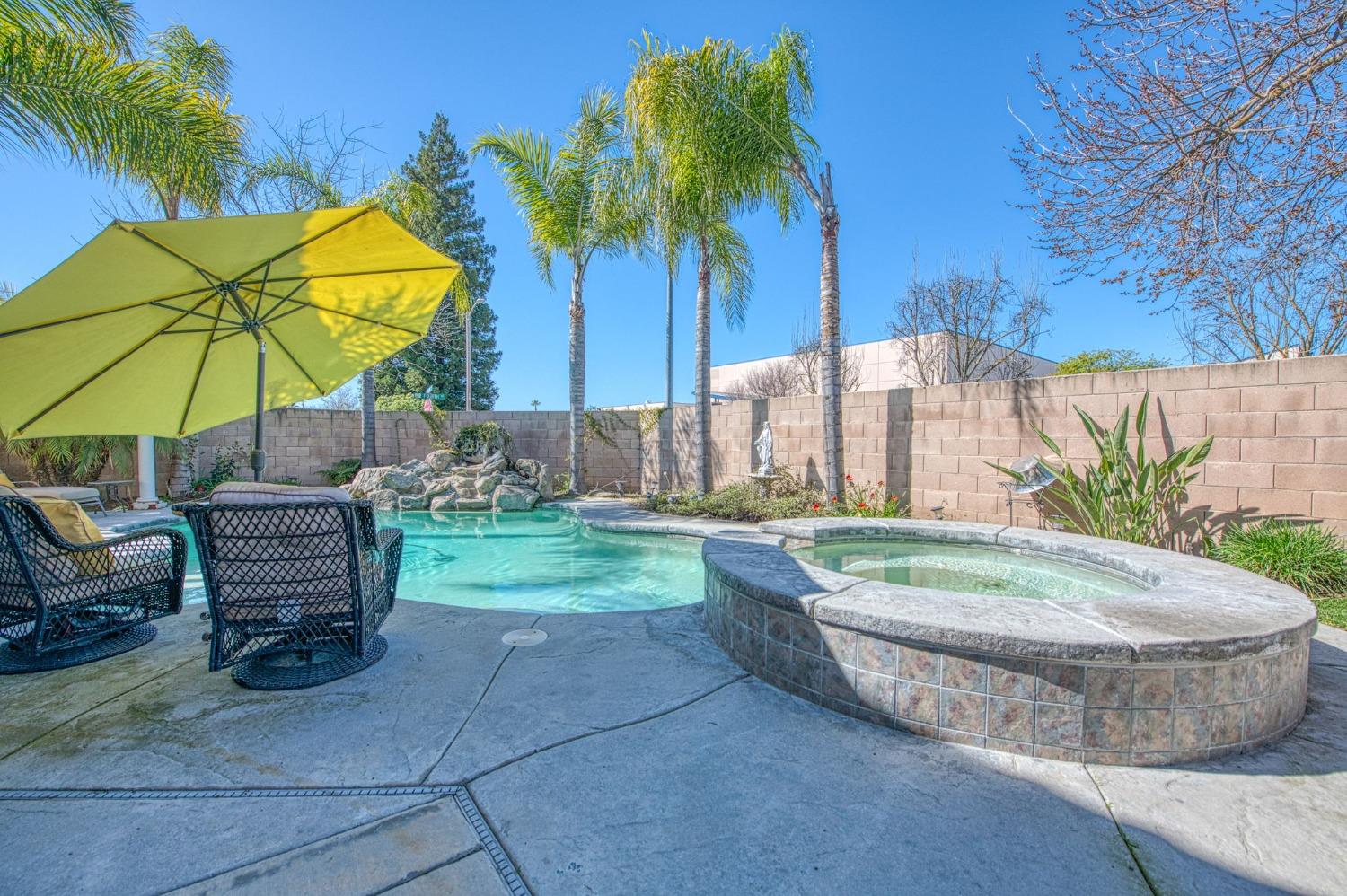901 Maple Street Parlier, CA 93648 - Photo 43 of 67 a view of a swimming pool with a lounge chairs