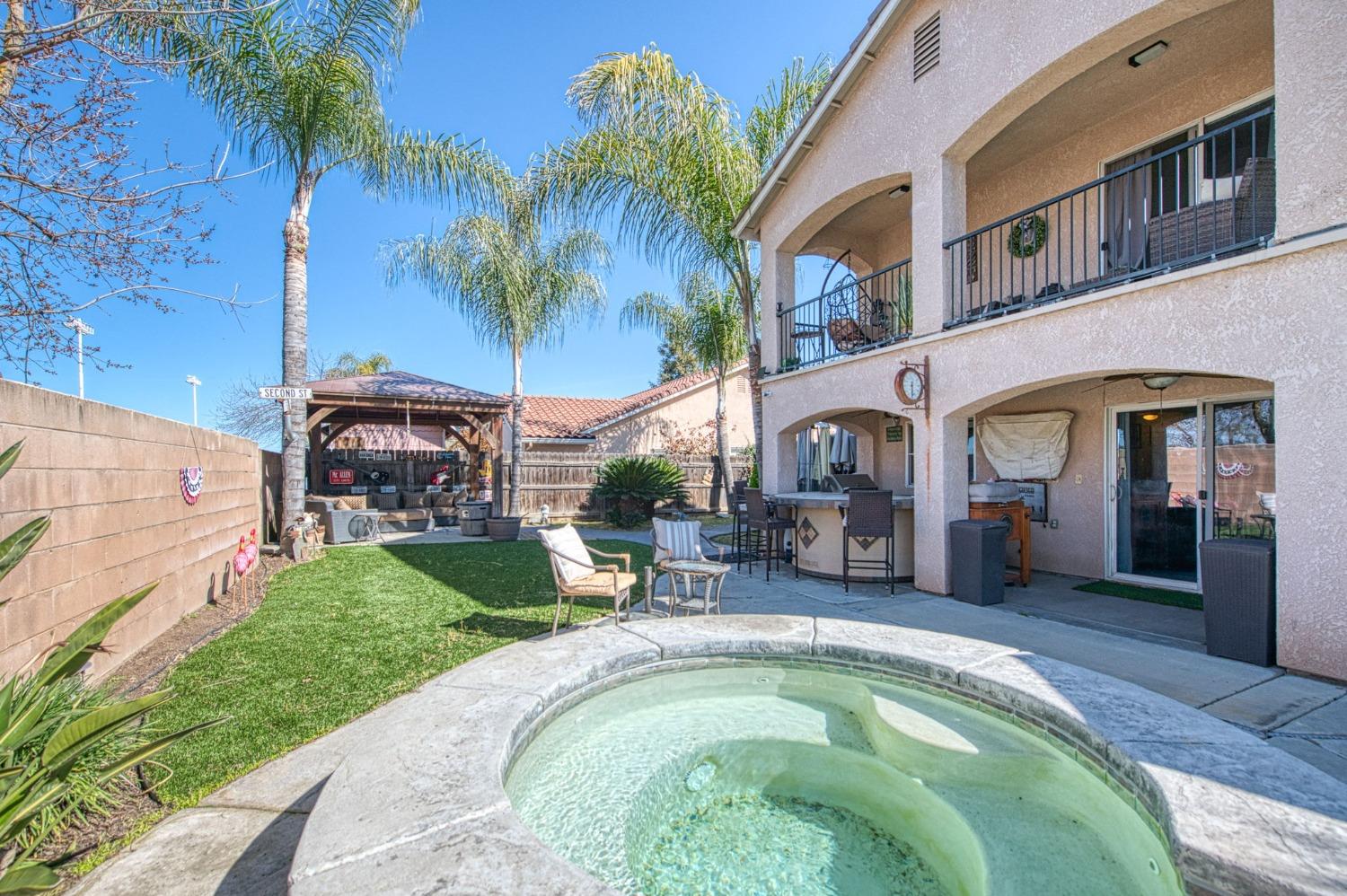 901 Maple Street Parlier, CA 93648 - Photo 47 of 67 a swimming pool with outdoor seating and yard