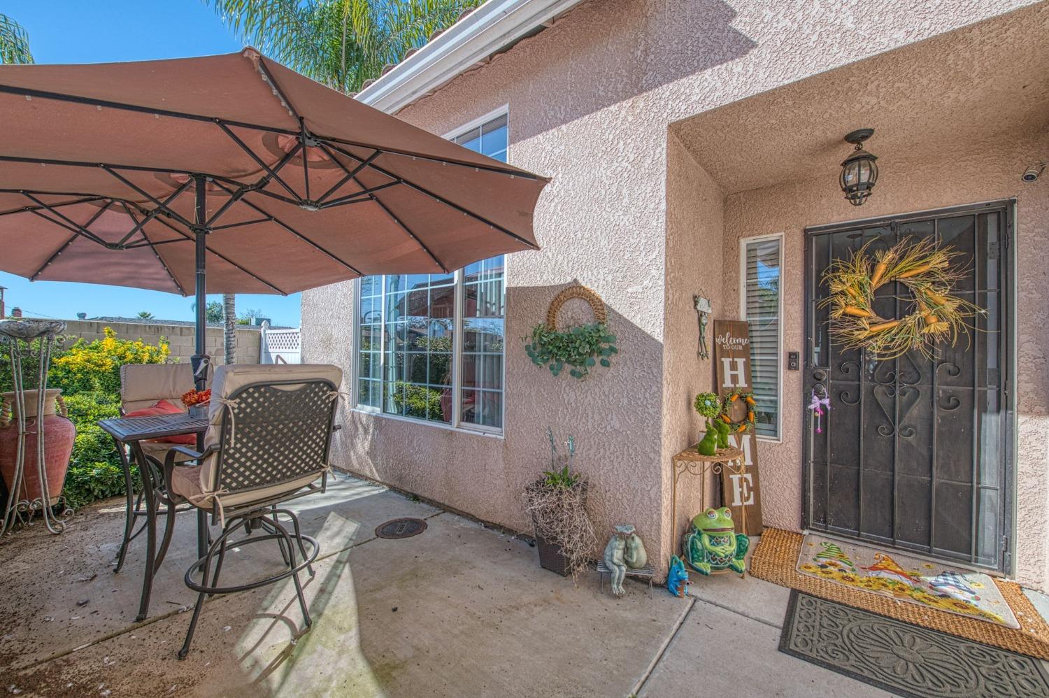 901 Maple Street Parlier, CA 93648 - Photo 59 of 67 a view of a patio with a table and chairs under an umbrella