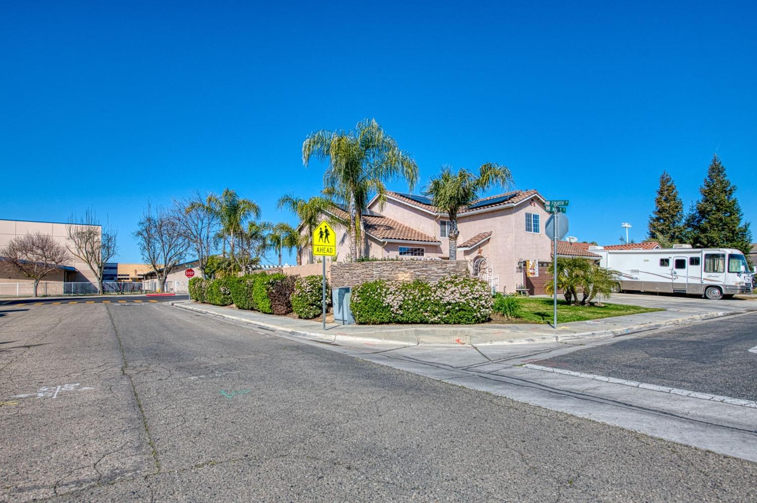 901 Maple Street Parlier, CA 93648 - Photo 66 of 67 a front view of a house with a yard and a garage