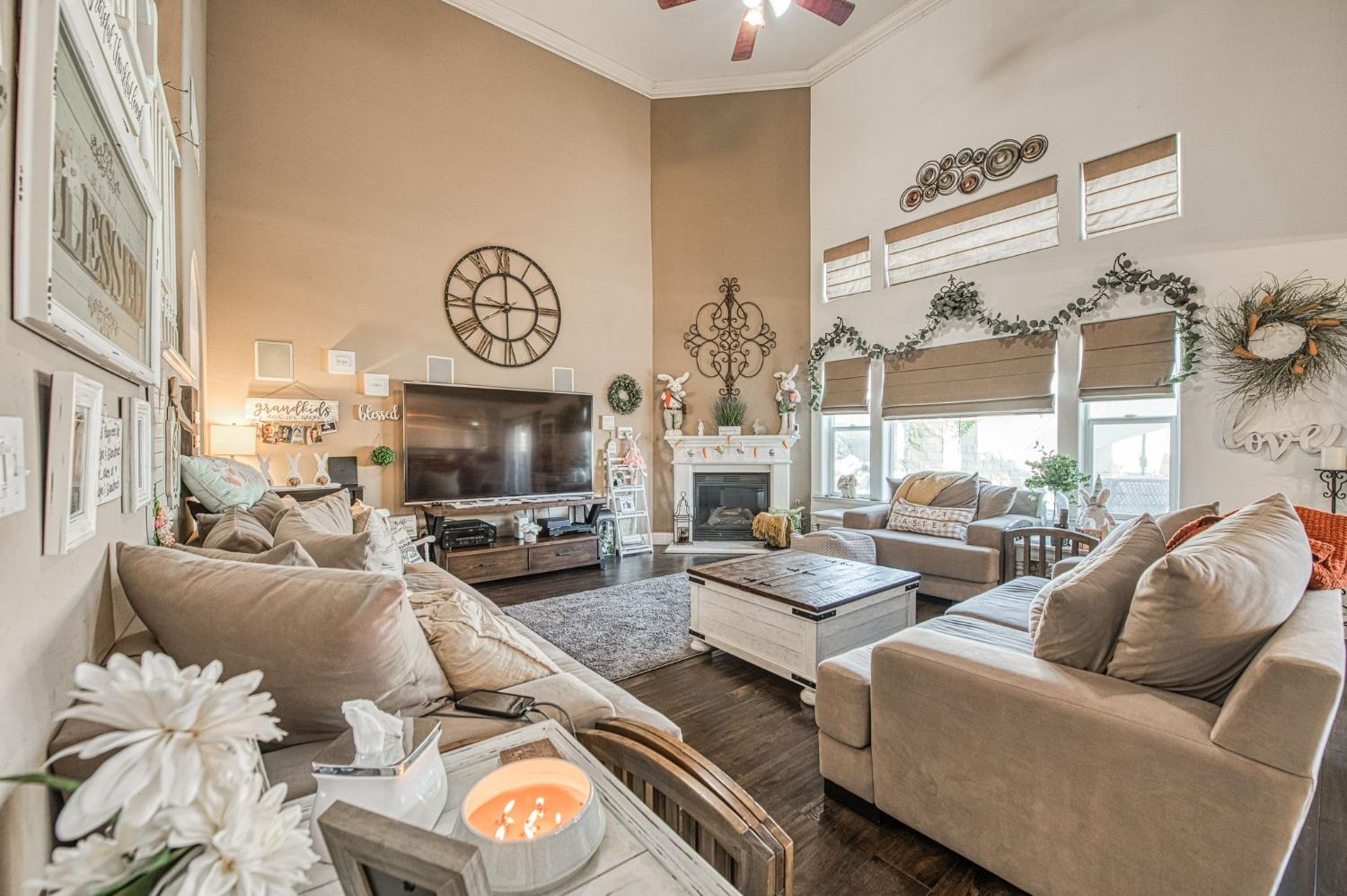 901 Maple Street Parlier, CA 93648 - Photo 8 of 67 a living room with furniture a chandelier and a flat screen tv