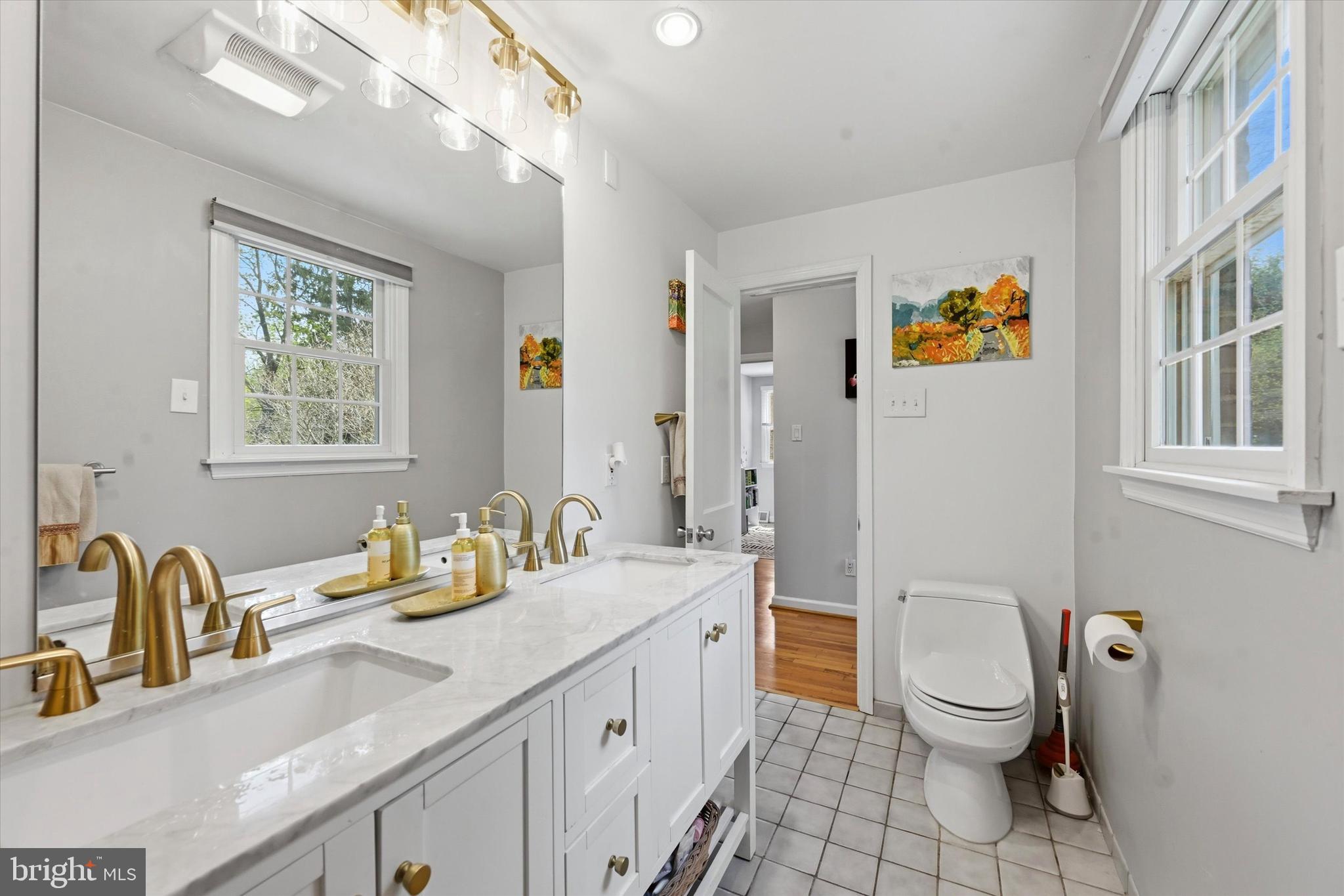 3 South Dillwyn Road Newark, DE 19711 - Photo 22 of 59 a bathroom with a granite countertop toilet sink and mirror