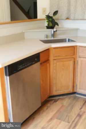 a kitchen with a sink and a mirror