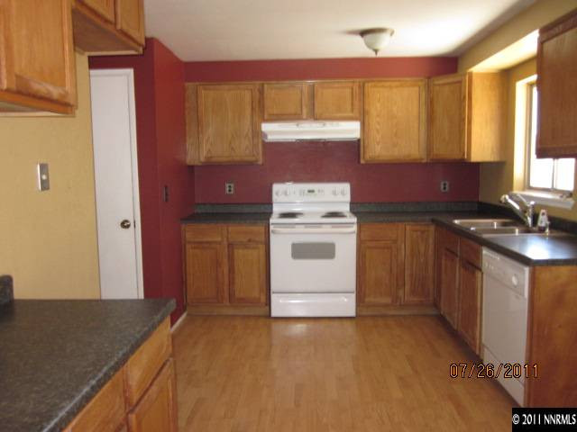 188 Ring Road Dayton, NV 89403 - Photo 4 of 9 a kitchen with a stove top oven sink and cabinets
