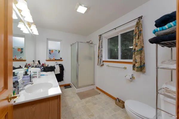 a bathroom with a sink toilet and shower
