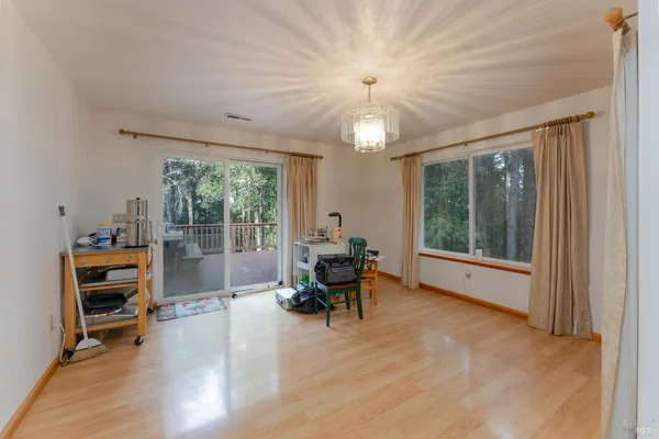 a view of a livingroom with furniture wooden floor and a large window