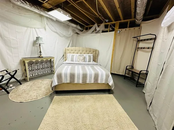 a bedroom with furniture and a flat screen tv