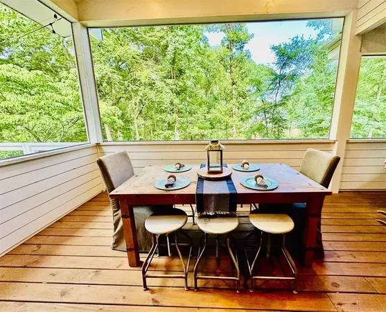 a living room with patio furniture and wooden floor