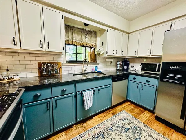 a view of a dining room with furniture a chandelier and wooden floor