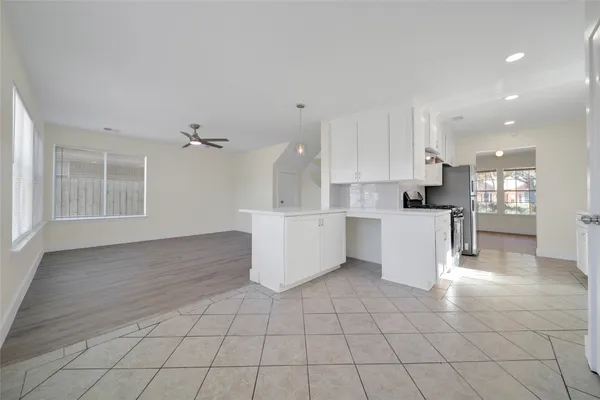 a open kitchen with cabinets and a stove top oven