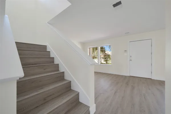 a view of an entryway with wooden floor