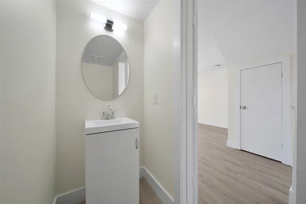 a bathroom with a sink a mirror and vanity