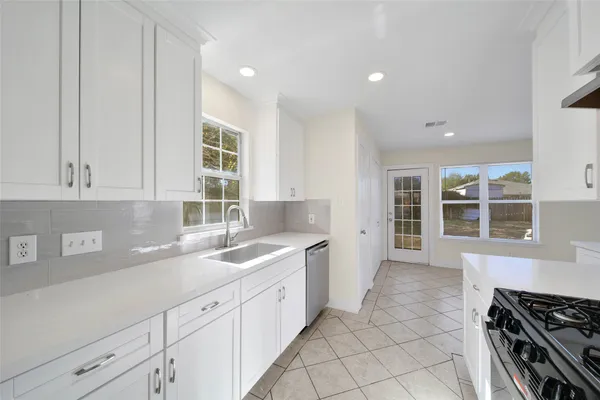 a kitchen with a sink and cabinets