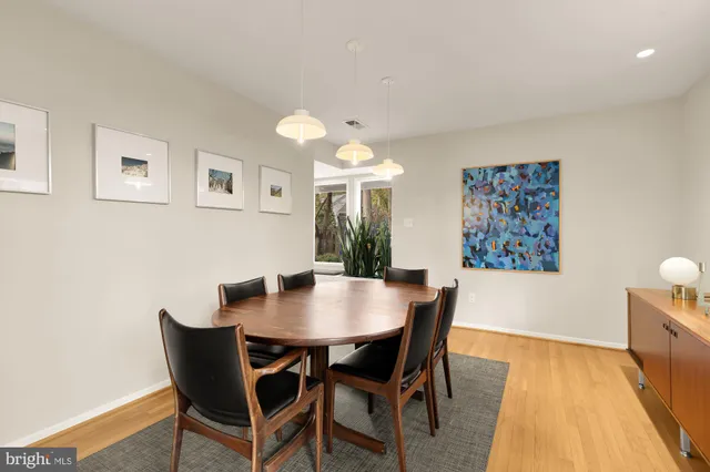 a kitchen with white cabinets and appliances