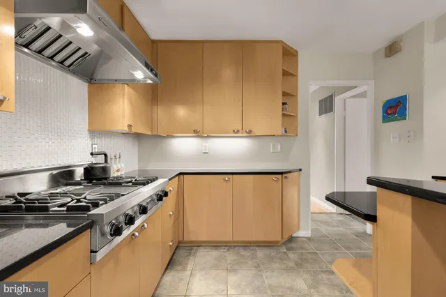 a view of a workspace with furniture and wooden floor