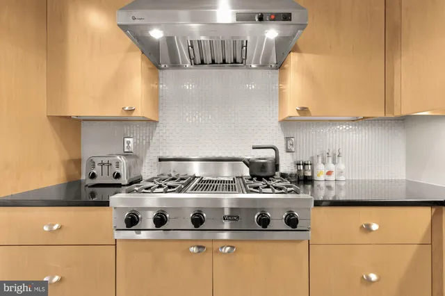 a living room with furniture a flat screen tv and a table