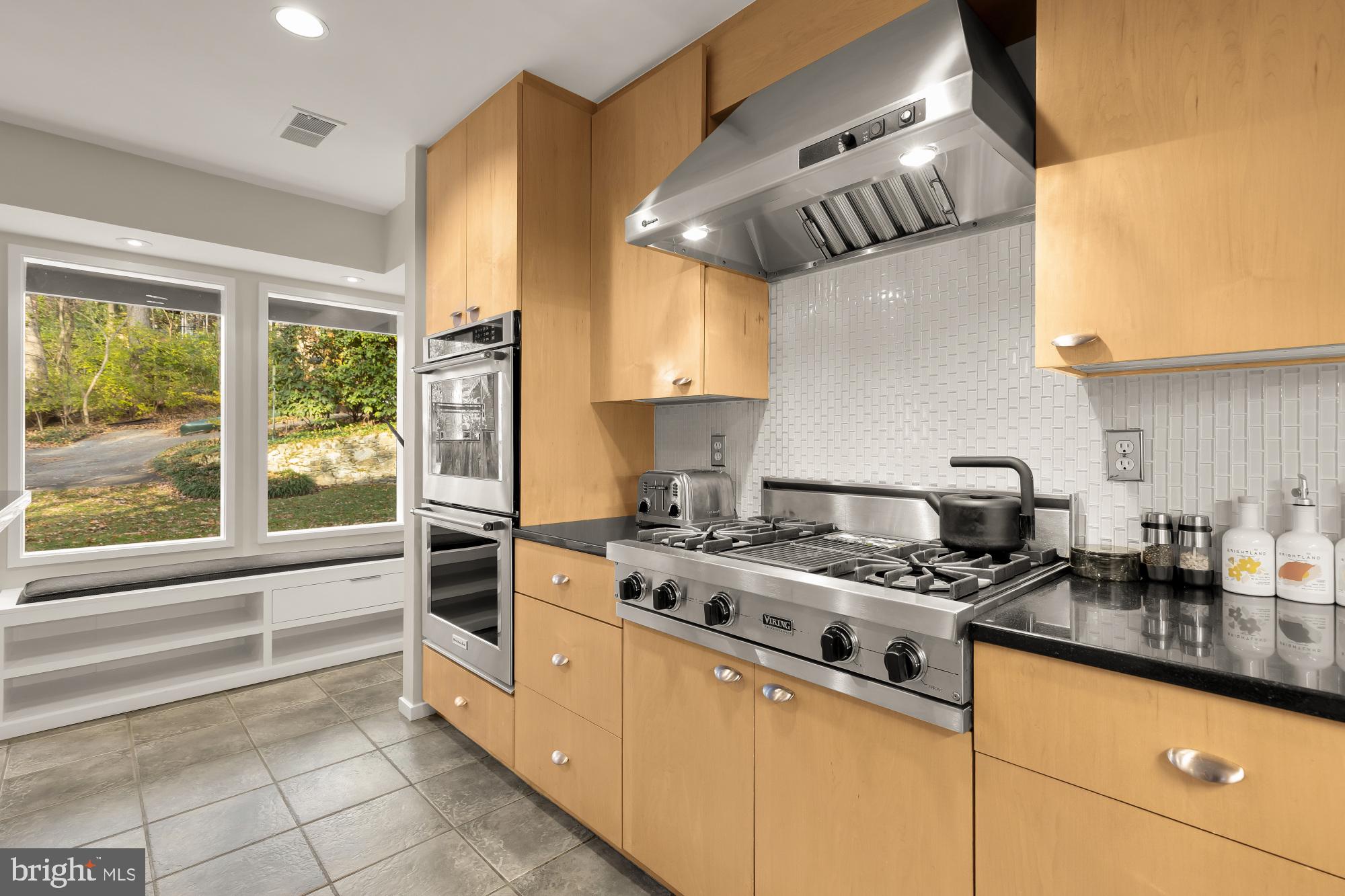 5420 Mohican Road Bethesda, MD 20816 - Photo 22 of 71 a kitchen with stainless steel appliances granite countertop a stove a sink and a microwave