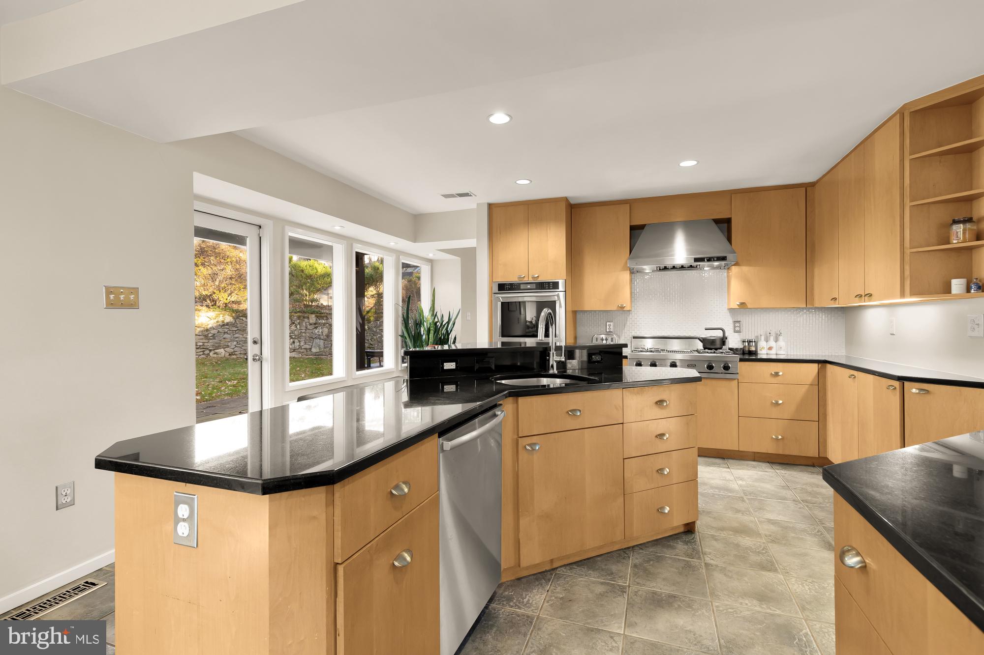 5420 Mohican Road Bethesda, MD 20816 - Photo 23 of 71 a kitchen with granite countertop a sink and white cabinets