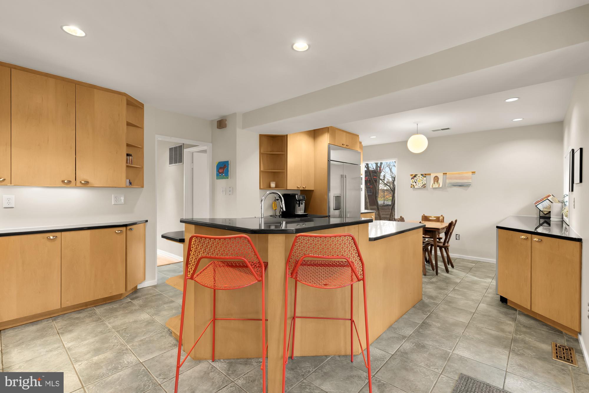 5420 Mohican Road Bethesda, MD 20816 - Photo 27 of 71 a large kitchen with kitchen island a sink a stove a dining table and chairs