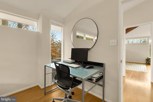 a bedroom with a bed and dresser with mirror