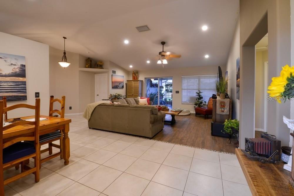 11347 Walden Loop Parrish, FL 34219 - Photo 11 of 29 a living room with furniture gym equipment and a chandelier