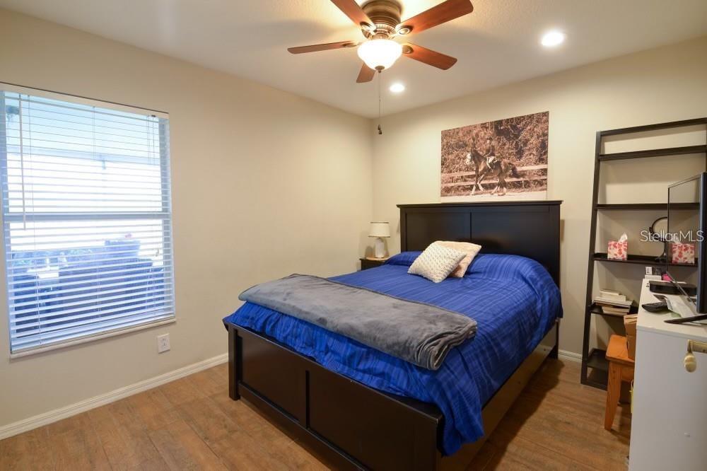 11347 Walden Loop Parrish, FL 34219 - Photo 12 of 29 a bed sitting in a bedroom next to a window