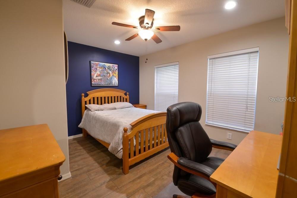 11347 Walden Loop Parrish, FL 34219 - Photo 13 of 29 a bedroom with a bed and chair