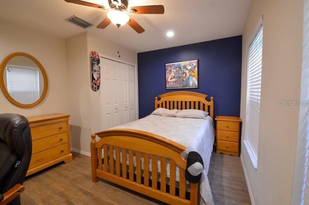 11347 Walden Loop Parrish, FL 34219 - Photo 14 of 29 a bedroom with a bed and a chandelier