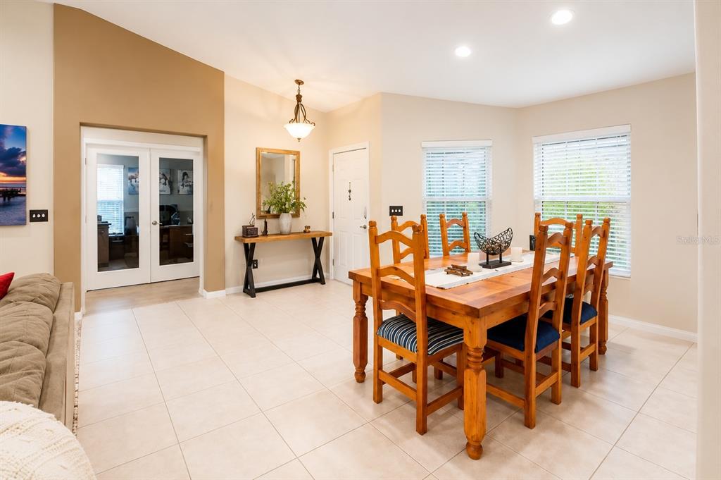 11347 Walden Loop Parrish, FL 34219 - Photo 4 of 29 a dining room with furniture and wooden floor