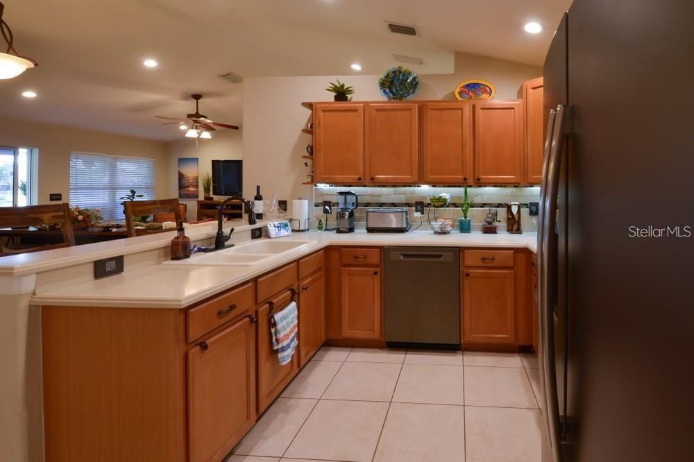 11347 Walden Loop Parrish, FL 34219 - Photo 6 of 29 a kitchen with a sink a stove and cabinets