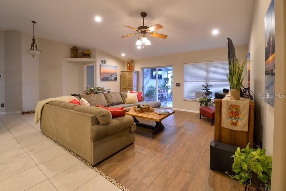 11347 Walden Loop Parrish, FL 34219 - Photo 9 of 29 a living room with furniture and a chandelier