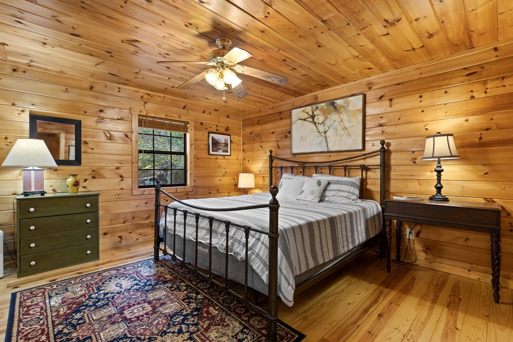 96 Holiday Court Ellijay, GA 30540 - Photo 22 of 51 a bedroom with a bed and a dresser