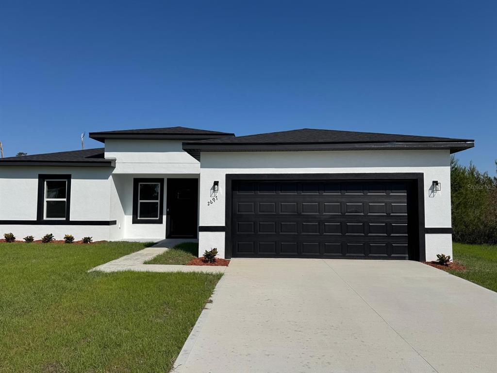 2697 Southwest 165th St Road Ocala, FL 34473 - Photo 1 of 1 a front view of a house with a yard