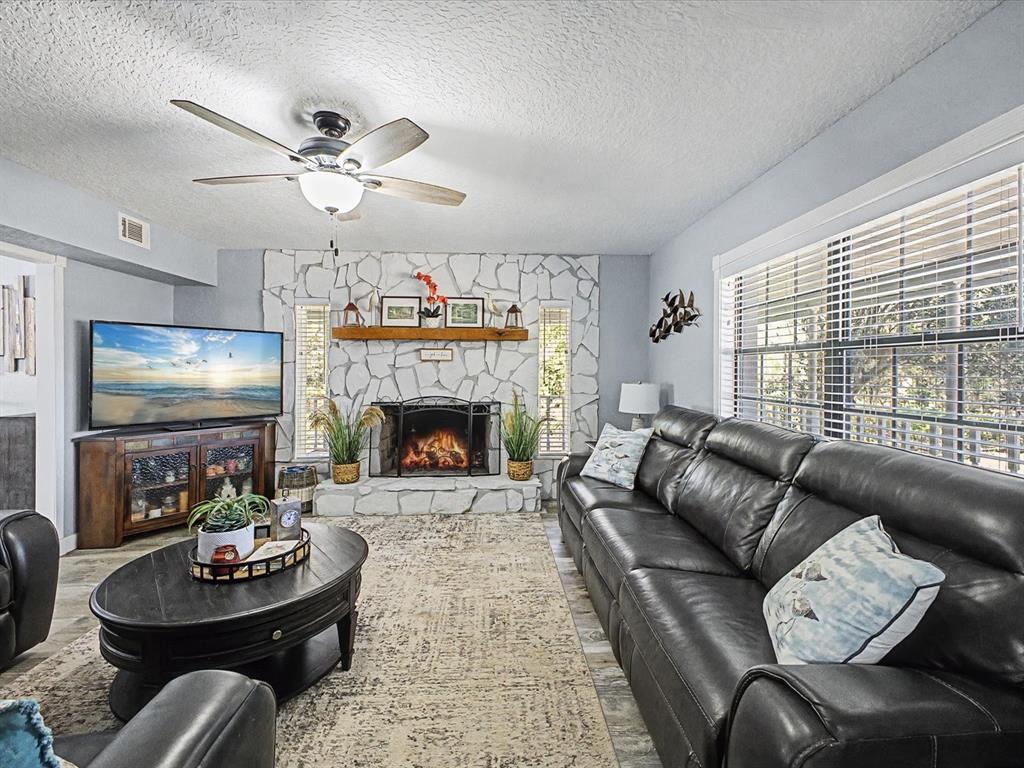 24420 Lanark Road Brooksville, FL 34601 - Photo 11 of 56 a living room with furniture and a fireplace