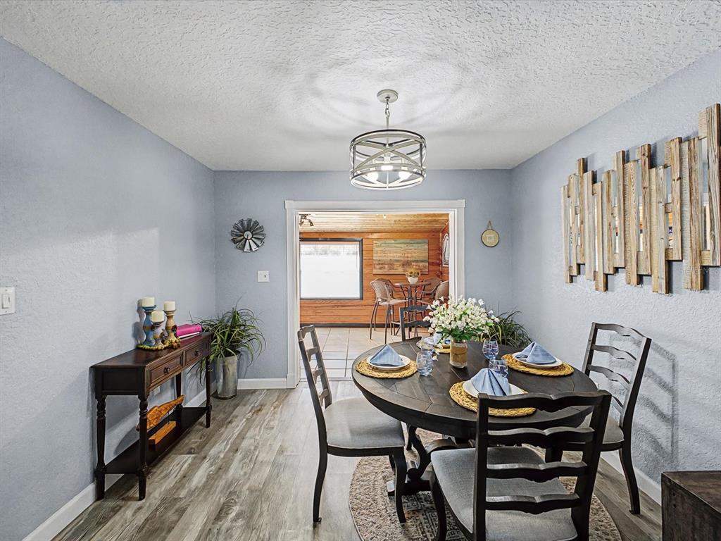 24420 Lanark Road Brooksville, FL 34601 - Photo 14 of 56 a view of a dining room with furniture and chandelier