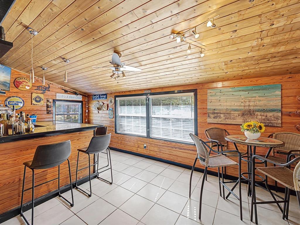 24420 Lanark Road Brooksville, FL 34601 - Photo 16 of 56 a dining room with furniture and a window