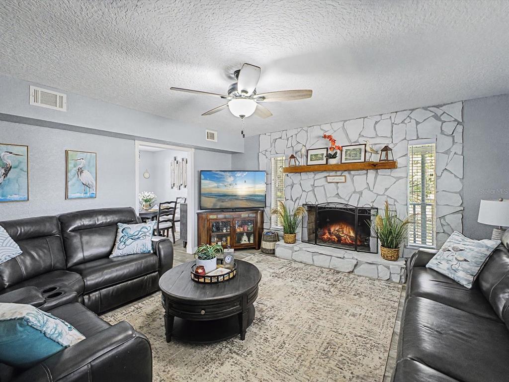 24420 Lanark Road Brooksville, FL 34601 - Photo 2 of 56 a living room with furniture and a fireplace