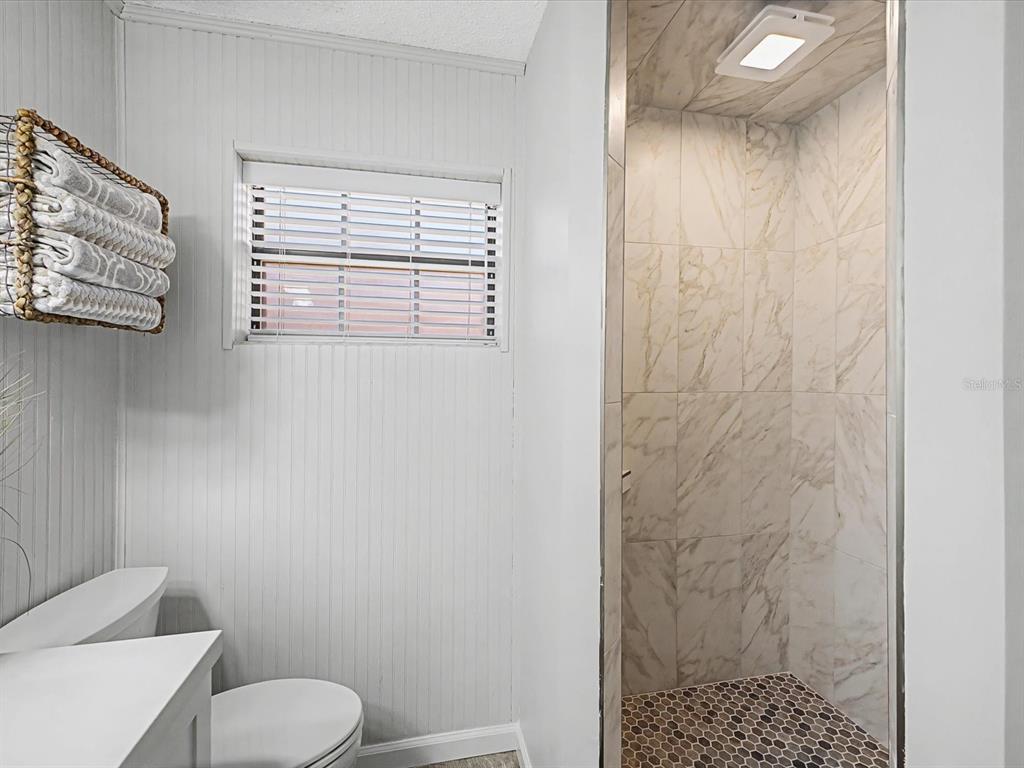 24420 Lanark Road Brooksville, FL 34601 - Photo 22 of 56 a bathroom with a toilet and a shower