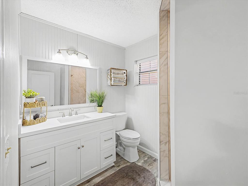 24420 Lanark Road Brooksville, FL 34601 - Photo 23 of 56 a bathroom with a toilet sink and mirror