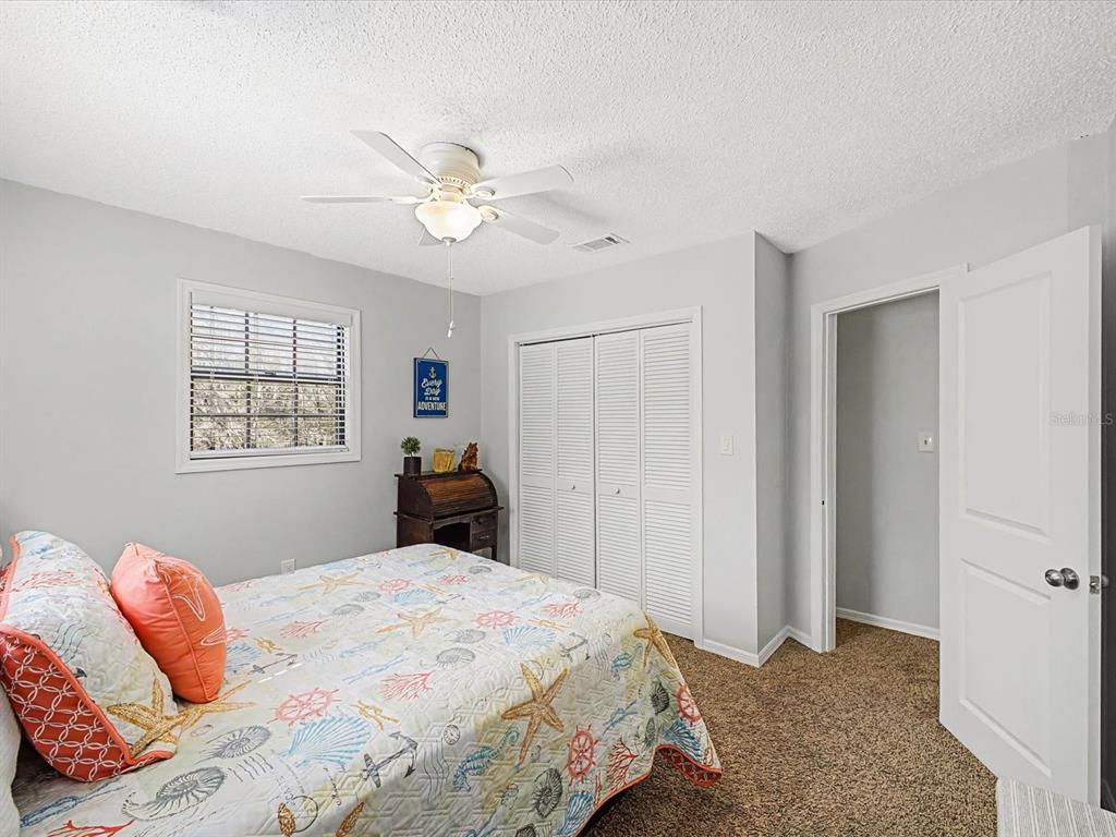 24420 Lanark Road Brooksville, FL 34601 - Photo 25 of 56 a bedroom with a bed and a window