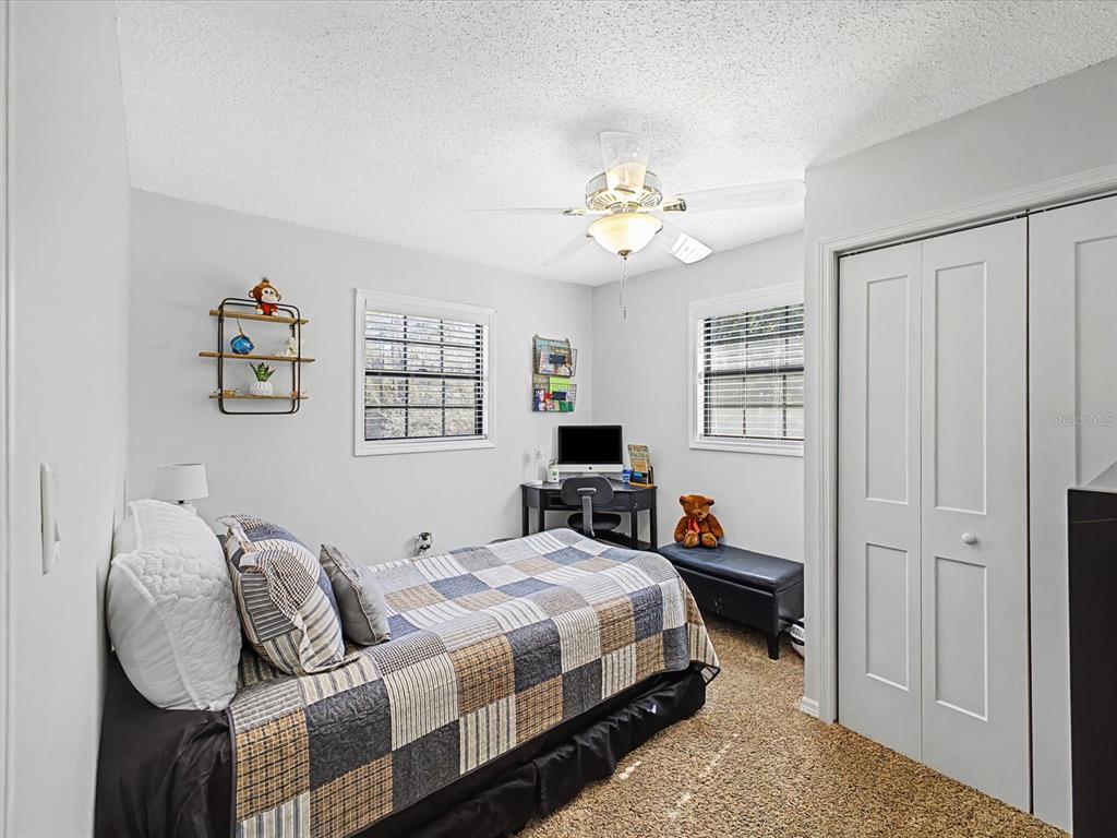 24420 Lanark Road Brooksville, FL 34601 - Photo 26 of 56 a bedroom with bed and window