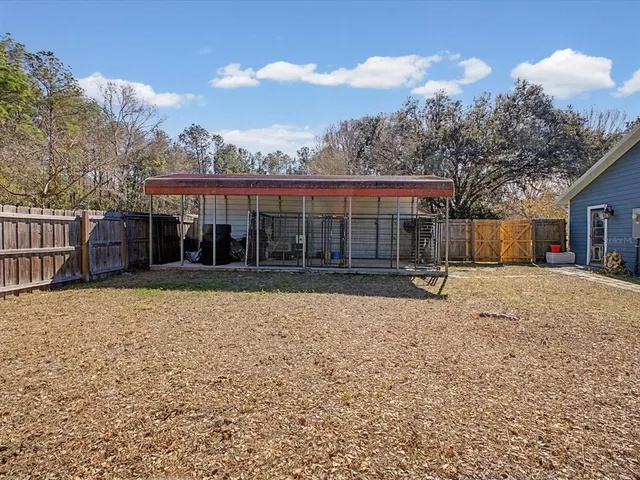 an aerial view of a house with a yard and garden