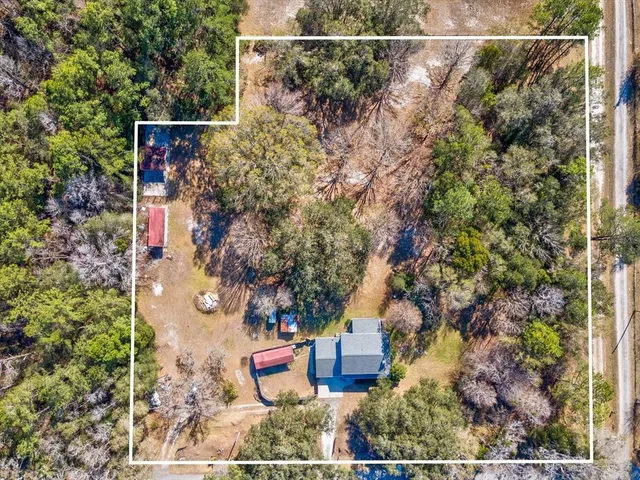 an aerial view of a houses with a yard