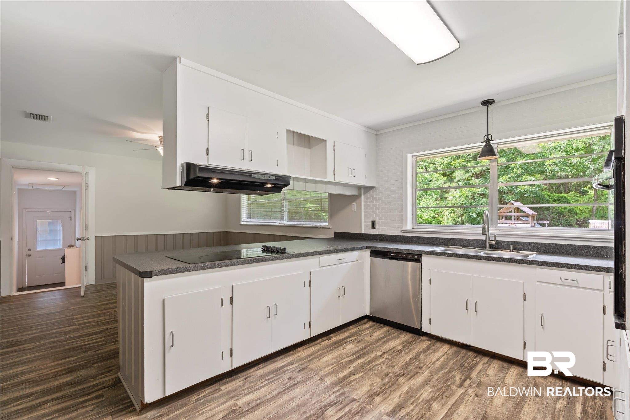 3325 Lacoste Road Mobile, AL 36618 - Photo 6 of 35 Kitchen featuring sink, stainless steel dishwasher, dark hardwood / wood-style flooring, and white cabinets