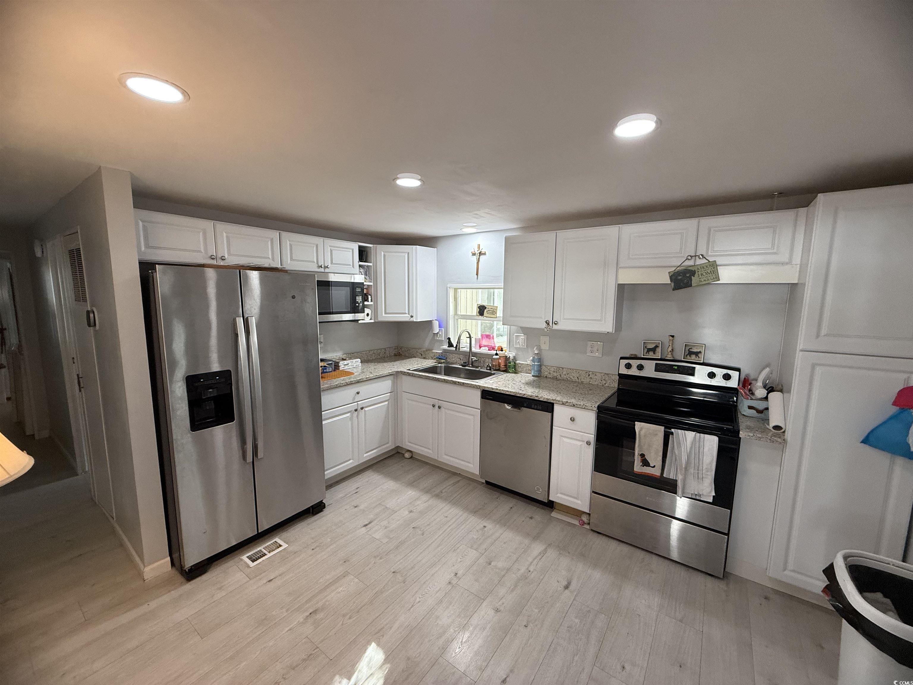 2945 Clemson Trail Murrells Inlet, SC 29576 - Photo 11 of 23 Kitchen featuring appliances with stainless steel finishes, white cabinetry, recessed lighting, and light wood-style floors
