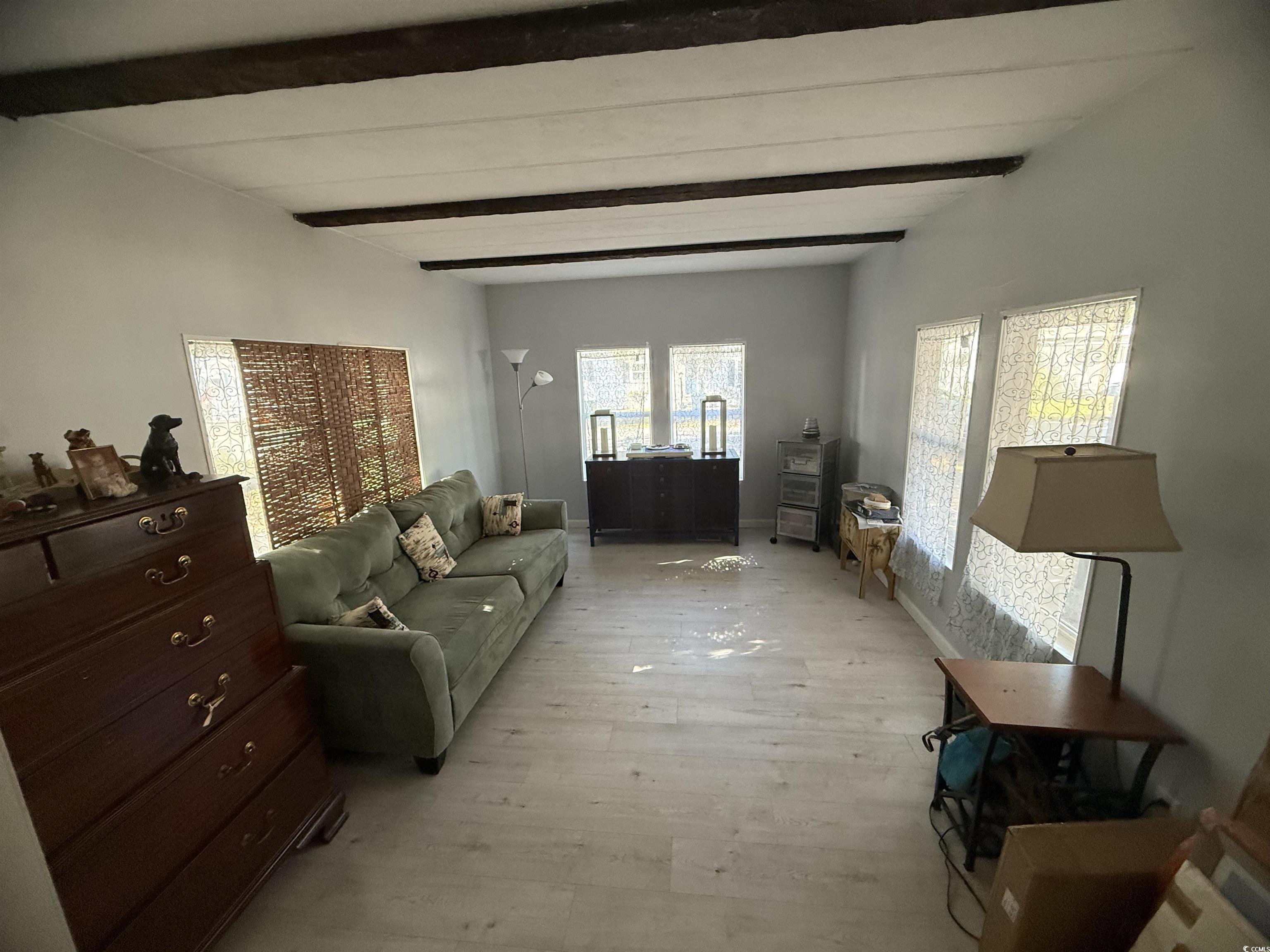 2945 Clemson Trail Murrells Inlet, SC 29576 - Photo 9 of 23 Living area with beamed ceiling and light wood-style floors